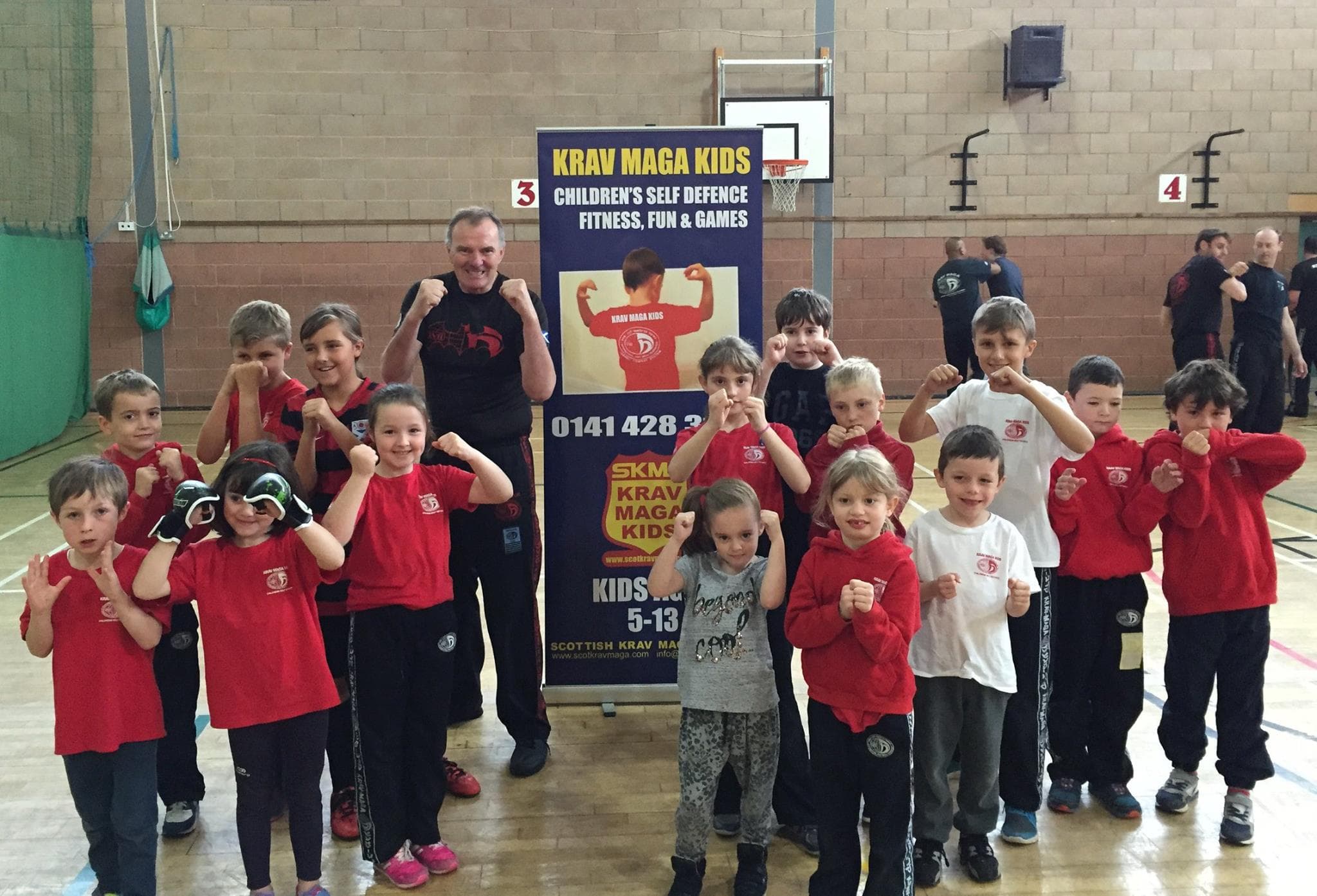 young kids facing the camera with their fists up